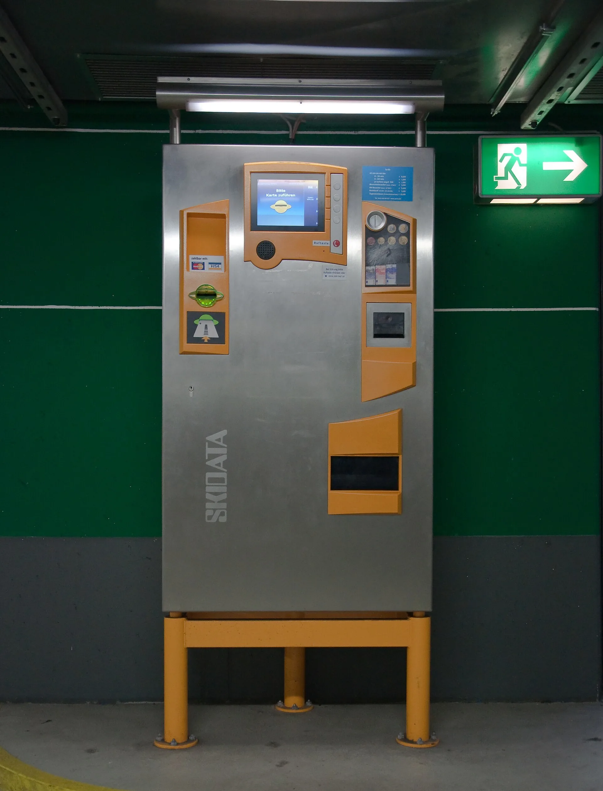 Self-service parking payment kiosk installed against a prepared base